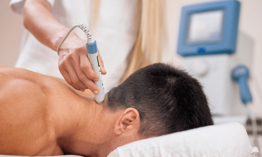 A person receives neck therapy with a handheld device, while a clinician administers treatment in a clinical setting.